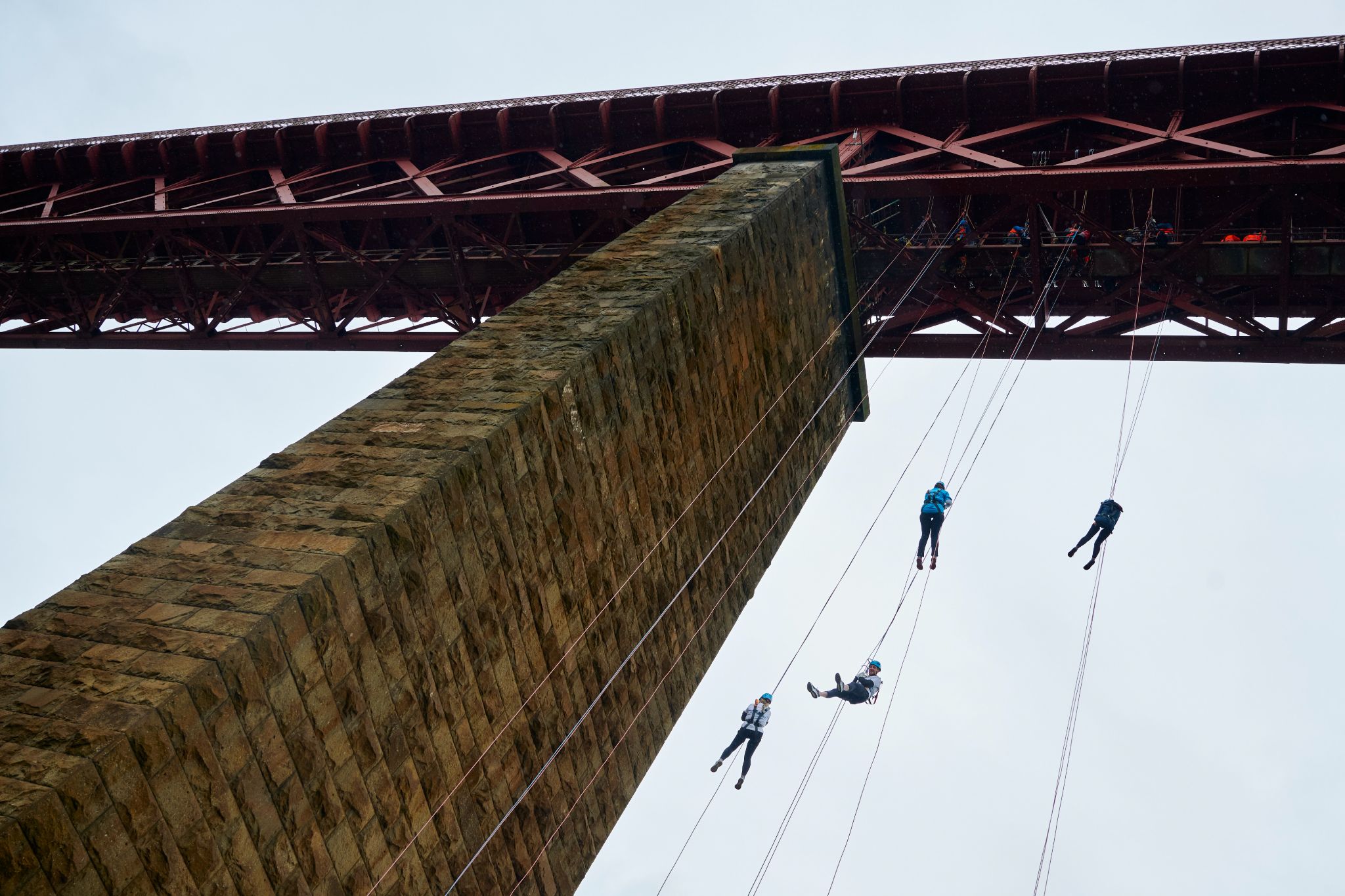 SITE Scotland members abseiling down Forth Rail Bridge.